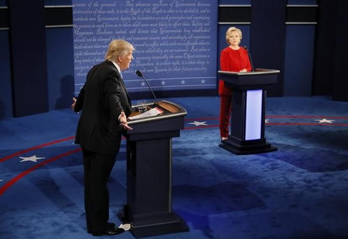 Republican U.S. presidential nominee Donald Trump speaks as Democratic U.S. presidential nominee Hillary Clinton listens during their first presidential debate at Hofstra University in Hempstead, New York, U.S., September 26, 2016. REUTERS/Rick Wilking