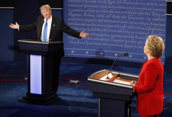 Republican U.S. presidential nominee Donald Trump speaks as Democratic U.S. presidential nominee Hillary Clinton listens during their first presidential debate at Hofstra University in Hempstead, New York, U.S., September 26, 2016. REUTERS/Rick Wilking