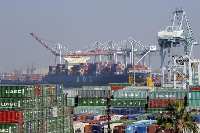 Cargo containers sit idle at the Port of Los Angeles as a back-log of over 30 container ships sit anchored outside the Port in Los Angeles, California, February 18, 2015. REUTERS/Bob Riha, Jr.