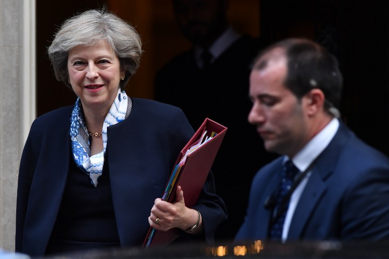 British Prime Minister Theresa May leaves 10 Downing street in London on October 12, 2016. British Prime Minister Theresa May signalled ahead of a House of Commons debate today that she would let parliament scrutinise her plan for Brexit before she begins the formal process to exit the EU. / AFP PHOTO / BEN STANSALL