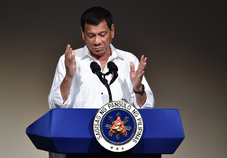 Philippines' President Rodrigo Duterte delivers a speech at the Philippines' Economic Forum in Tokyo on October 26, 2016. Duterte was set on October 26 to persuade Japanese executives his country is "open for business", after upending traditional alliances by insulting the US and making overtures to China. / AFP PHOTO / KAZUHIRO NOGI