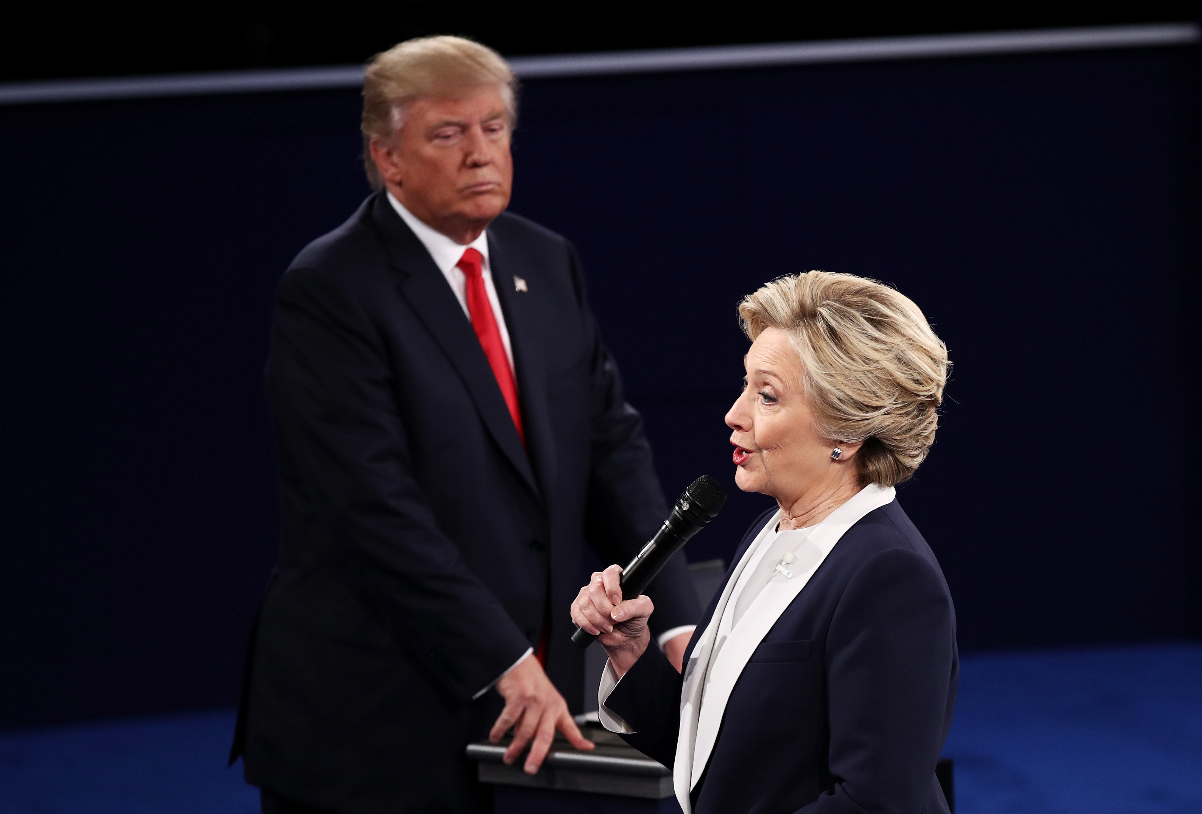 ST LOUIS, MO - OCTOBER 09: Democratic presidential nominee former Secretary of State Hillary Clinton (R) speaks as Republican presidential nominee Donald Trump looks on during the town hall debate at Washington University on October 9, 2016 in St Louis, Missouri. This is the second of three presidential debates scheduled prior to the November 8th election.   Win McNamee/Getty Images/AFP