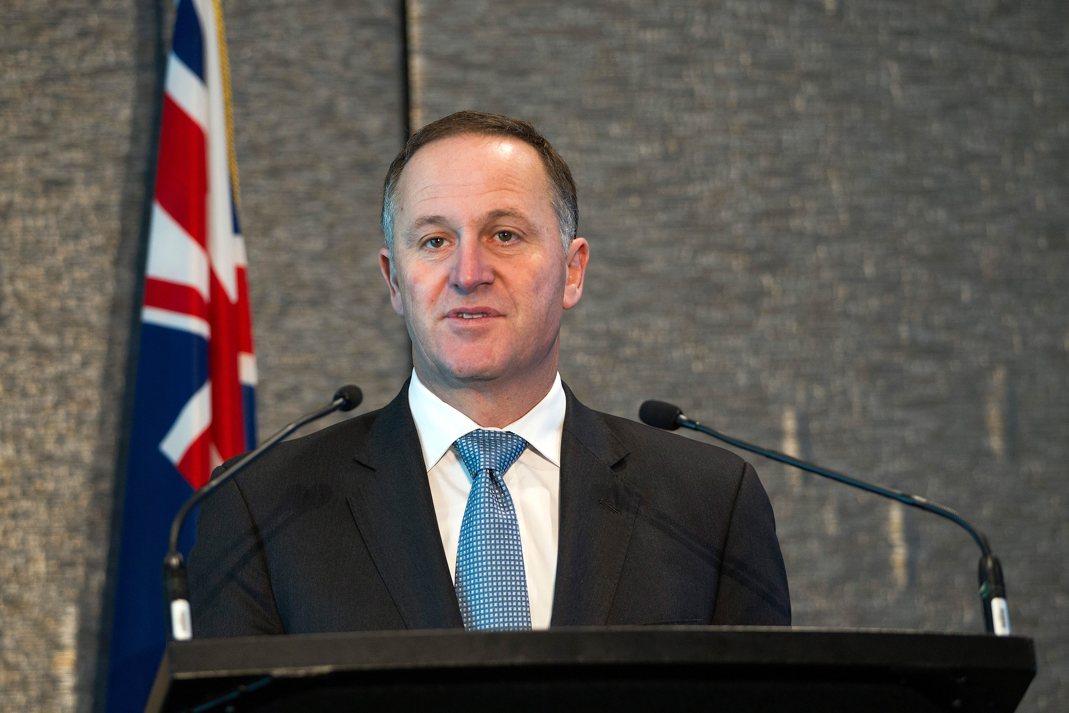 (FILES) This file photo taken on September 02, 2014 shows New Zealand Prime Minister John Key speaking at a joint press conference with the visiting  United Nations Secretary General Ban Ki-moon in Auckland on September 2, 2014.  Key announced his resignation on December 5, 2016. / AFP PHOTO / DAVID ROWLAND