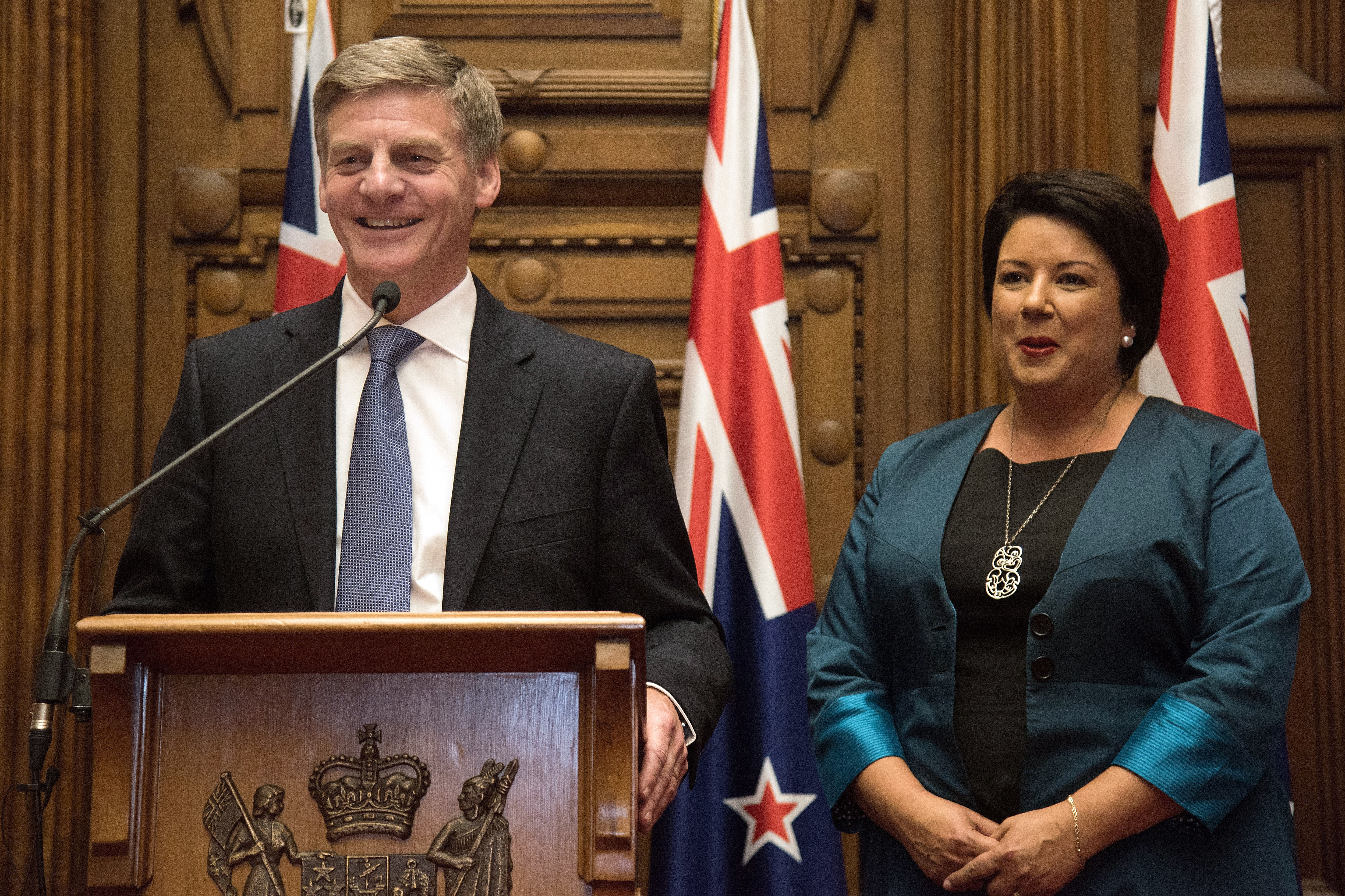 New Zealand's new Prime Minister Bill English (L) speaks to the media beside his deputy Paula Bennett during a press conference at Parliament in Wellington on December 12, 2016.  New Zealand's ruling National Party appointed Bill English as the country's new prime minister on December 12 following last week's shock resignation of his predecessor John Key. / AFP PHOTO / Marty Melville