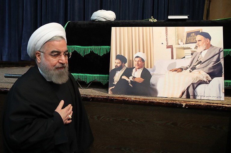 A handout photo provided by the office of the Iranian President Hasan Rouhani shows him praying next to the coffin of former Iranian president Akbar Hashemi Rafsanjani during a mourning ceremony at the Jamaran mosque in Tehran on January 9, 2017.  Rafsanjani died in hospital on January 8 after suffering a heart attack. Rafsanjani, who was 82, was a pivotal figure in the foundation of the Islamic republic in 1979, and served as president from 1989 to 1997.  / AFP PHOTO / IRANIAN PRESIDENCY / HO / RESTRICTED TO EDITORIAL USE - MANDATORY CREDIT "AFP PHOTO / IRANIAN PRESIDENCY" - NO MARKETING - NO ADVERTISING CAMPAIGNS - DISTRIBUTED AS A SERVICE TO CLIENTS