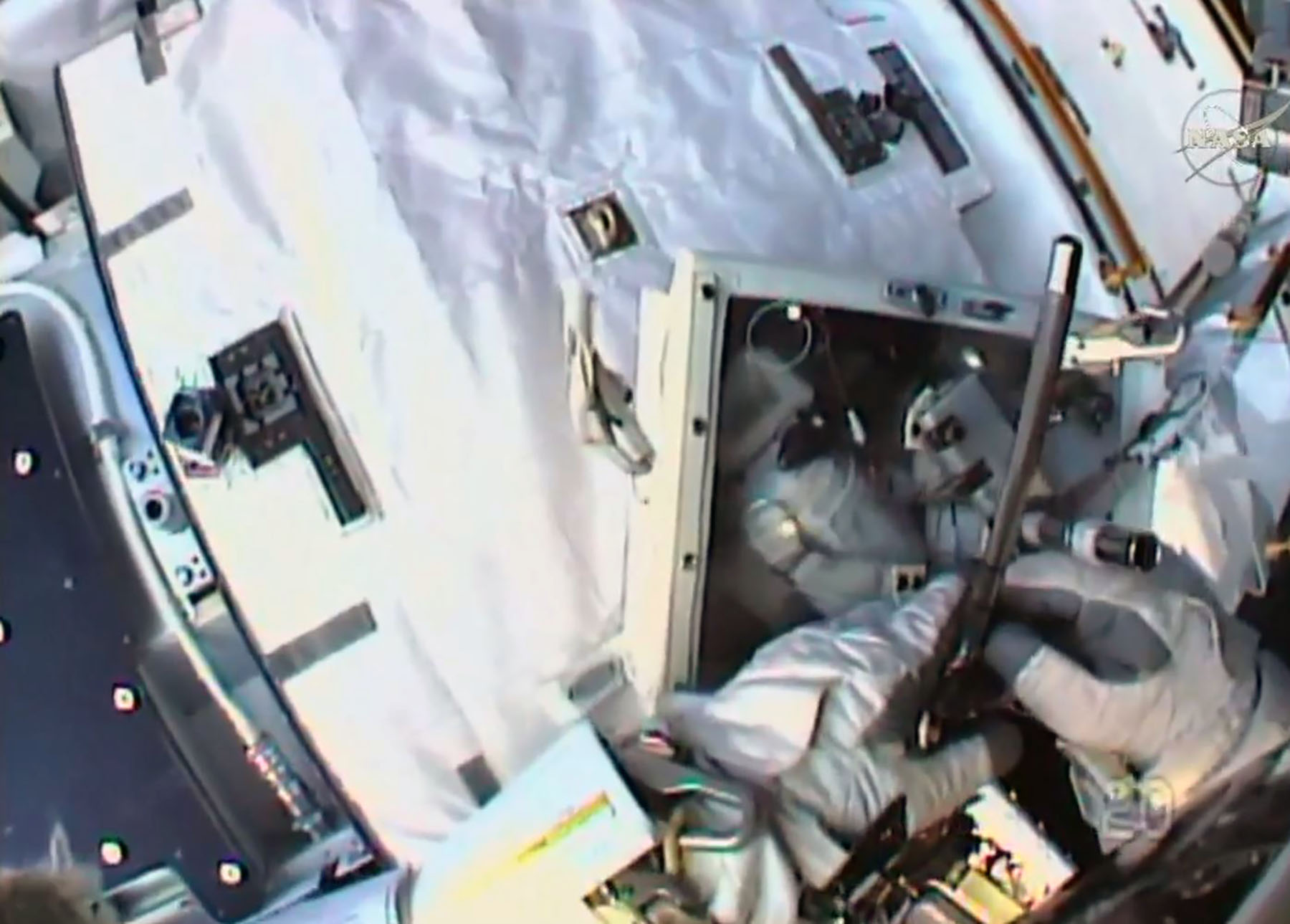 This NASA TV grab image shows French astronaut Thomas Pesquet as he removes a battery outside the International Space Staion on January 13, 2017. French astronaut Thomas Pesquet floated into space on his first-ever spacewalk January 13, 2017, on a mission to help upgrade the power system outside the International Space Station with new, refrigerator-sized lithium-ion batteries. Wearing a white spacesuit with the French flag emblazoned on one shoulder, Pesquet and American astronaut Shane Kimbrough switched on their spacesuits' internal battery power to mark the official start of the spacewalk at 6:22 am (1122 GMT), more than a half hour earlier than scheduled.  / AFP PHOTO / NASA TV / Handout / RESTRICTED TO EDITORIAL USE - MANDATORY CREDIT AFP PHOTO /NASA TV  - NO MARKETING - NO ADVERTISING CAMPAIGNS - DISTRIBUTED AS A SERVICE TO CLIENTS