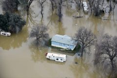 A home is seen marooned as the surrounding property is submerged in flood water in Oroville, California on February 13, 2017.  Almost 200,000 people were under evacuation orders in northern California Monday after a threat of catastrophic failure at the United States' tallest dam. Officials said the threat had subsided for the moment as water levels at the Oroville Dam, 75 miles (120 kilometers) north of San Francisco, have eased. But people were still being told to stay out of the area.  / AFP PHOTO / Josh Edelson