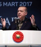 This handout photo taken and released on March 5, 2017 by the Turkish Presidential Press Service shows Turkey's President Recep Tayyip Erdogan addresses a crowd during a Meeting of Women and Democracy Event organized by KADEM (Women and Democracy Association) in Istanbul.  Turkish President Recep Tayyip Erdogan lashed out at Germany on March 5 for blocking rallies in support of him ahead of a vote on boosting his powers, likening the ban to "Nazi practices". The attack came a day after German Chancellor Angela Merkel called Turkish Prime Minister Binali Yildirim to try to defuse the row, which has put a major new strain on already bruised ties between the NATO allies.  / AFP PHOTO / TURKISH PRESIDENTIAL PRESS SERVICE / MURAT CETIN MUHURDAR