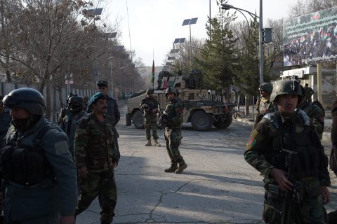 Afghan security personnel stand guard in front of the main gate of a military hospital in Kabul on March 8, 2017, after a deadly six-hour attack claimed by the Islamic State group. More than 30 people were killed and around 50 wounded in an insurgent attack on Afghanistan's largest military hospital in Kabul on March 8, the defence ministry said. / AFP PHOTO / SHAH MARAI