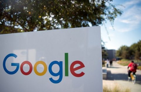 (FILES) This file photo taken on November 4, 2016 shows a man rideing a bike past a Google sign and logo at the Googleplex in Menlo Park, California. Google painted a bleak picture of cybersecurity trends March 20, 2017, saying the number of websites hacked rose 32 percent last year, with little relief in sight."We don't expect this trend to slow down. As hackers get more aggressive and more sites become outdated, hackers will continue to capitalize by infecting more sites," Google said in a post on its webmaster blog.  / AFP PHOTO / JOSH EDELSON