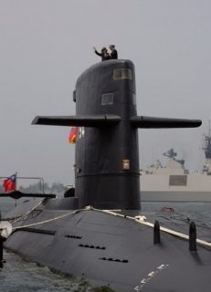 Taiwan President Tsai Ing-wen waves from a Duch-made Sea Tiger submarine at the Tsoying navy base in Kaohsiung, southern Taiwan on March 21, 2017.  Taiwan formally launched an ambitious project to build its own submarines as the island faces growing military threats from China as relations deteriorate. / AFP PHOTO / SAM YEH