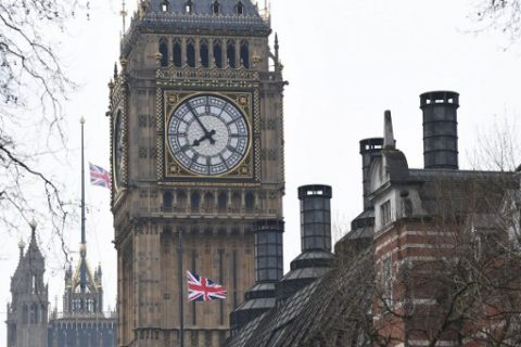 Union flags fly at half mast from Portcullis house and the Houses of Parliament on March 23, 2017. Seven people have been arrested including in London and Birmingham over Wednesday's terror attack at the British parliament, the police said on today, revising down the number of victims to three people. / AFP PHOTO / Justin TALLIS