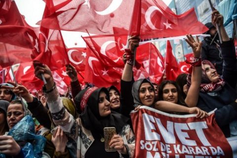 People wave national flags and cheer during a rally in  support of the Turkish President  on March 26, 2017 in Istanbul.   Turkish President Recep Tayyip Erdogan on March 26 lashed out again in the diplomatic row with the European Union saying it would be "easier" if the EU just rejected Turkey's bid to join the bloc. / AFP PHOTO / OZAN KOSE