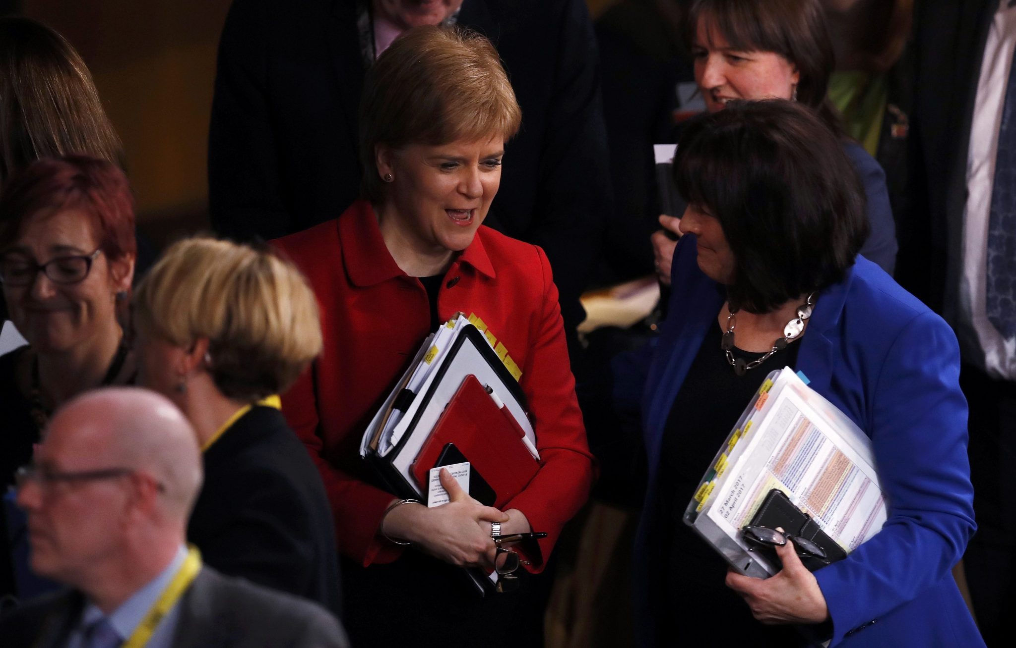 Scotland's First Minister Nicola Sturgeon (L) leaves after the vote on a second referendum on independence was carried at Scotland's Parliament in Holyrood, Edinburgh on March 28, 2017. Scotland's parliament today voted to allow First Minister Nicola Sturgeon to make a formal request to the British government to hold a new referendum on independence, on the eve of the formal launch of Brexit. / AFP PHOTO / POOL / RUSSELL CHEYNE