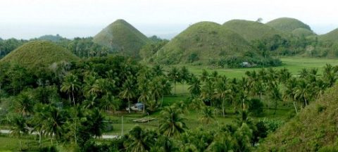 FILE PHOTOS; A bird's eye view of Chocolate Hills of Bohol island in central Philippines, 13 January 2005. Rising amidst rice fields and coconut grooves in six towns in the interior of the central island of Bohol, the grassy hills were once coral reefs that erupted from the sea in a massive geologic shift. wind and water put on the finishing touches over hundreds of thousands of years. The grass dies and crisps to a light brown in the dry season, causing the hills to resemble giant chocolate drops. This draws hundreds of thousands of awed visitors. The Philippines sent military reinforcements to one of its most famous tourist islands Wednesday as a deadly operation to flush out heavily armed Islamic militants entered its second day.AFP PHOTO JAY DIRECTO / AFP PHOTO / JAY DIRECTO