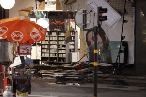 Damage to a store is revealed after the stolen truck, which was driven through a crowd outside a department in Stockholm on April 7, 2017, was taken away on April 8. A massive manhunt was underway for the driver of the stolen truck that ploughed into the crowd, killing four and injuring 15, Swedish police said. National police chief, Stefan Hector, said the police's "working hypothesis is that this is a terror attack." / AFP PHOTO / Odd ANDERSEN