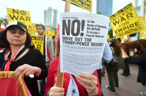 Demonstrators protest US air strikes against Syria in Los Angeles on April 7, 2017.  The United States on April 7 warned it was ready to hit Syria again after targeting an air base in a strike that infuriated Moscow and fueled calls for a new diplomatic push to end the six-year war.  / AFP PHOTO / FREDERIC J. BROWN