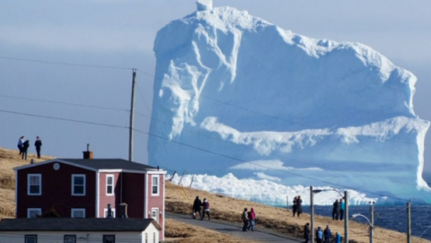 The reported first iceberg and sea ice of the season drifts off the coast of Canada's Newfoundland.(photo grabbed from Reuters video)