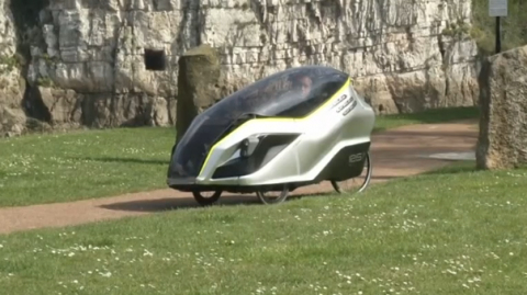 The nephew of famous British innovator Sir Clive Sinclair has designed a prototype three-wheeled electric cycle which he believes will succeed where his uncle infamously failed.(photo grabbed from Reuters video)