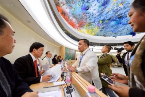 Head of the Philippines' delegation Menardo Guevarra (2nd L) speaks with a man prior to the start of universal periodic review of the Philippines by the Office of the United Nations High Commissioner for Human Rights (OHCHR) on May 8, 2017 at the UN offices in Geneva. ???????? The Philippines' record is reviewed by the UN human rights council for the first time since the inauguration of President Rodrigo Duterte, who has been accused of massive violations in his so-called drug war. / AFP PHOTO / Fabrice COFFRINI