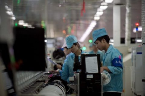 Factory employees work at the main factory of Chinese smartphone maker Oppo in Dongguan on May 8, 2017. Chinese exports rose for the second consecutive month in April, official data showed, boosted by improving global demand, but at a slower pace than in the previous month. / AFP PHOTO / Nicolas ASFOURI