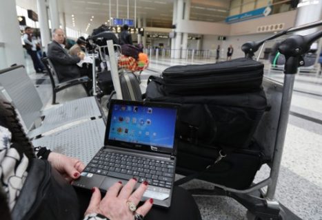 (FILES) This file photo taken on March 22, 2017 shows a Syrian woman travelling to the United States through Amman opening her laptop before checking in at Beirut international airport. US authorities are considering banning carry-on computers on European flights to the United States, widening the security measure introduced for flights from eight countries in March, an official said May 9, 2017. The Department of Homeland Security is close to making a decision on a wider ban as the busy summer transatlantic travel season looms, department spokesman David Lapan said.In March, Washington banned passengers on direct flights to the United States from 10 airports in eight countries from carrying on board laptop computers, tablets and other electronic devices larger than cellphones.The affected airports are in Turkey, North Africa and the Middle East. / AFP PHOTO / ANWAR AMRO