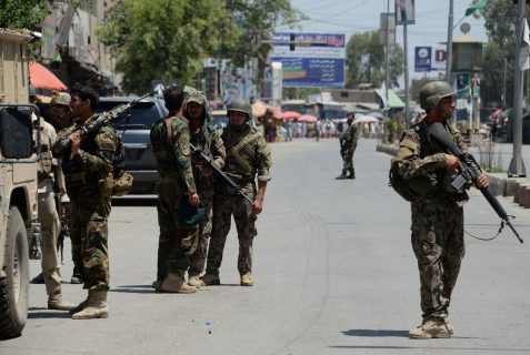 Afghan security forces stand at the site of suicide bombing in Jalalabad on May 17, 2017. Suicide bombers stormed the national television station in the eastern Afghan city of Jalalabad on May 17, triggering gunfights and explosions as journalists remained trapped inside the building, officials and eyewitnesses said. At least two people were killed and 14 others wounded in the ongoing assault, which underscores the growing dangers faced by media workers in Afghanistan. / AFP PHOTO / NOORULLAH SHIRZADA