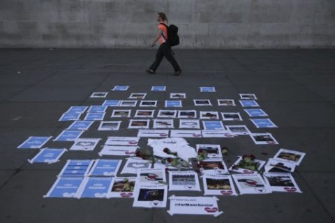 Posters in solidarity with the dead and injured from the terror attack in Manchester are arranged on the pavement in Trafalgar Square in central London on May 23, 2017. Twenty two people have been killed and dozens injured in Britain's deadliest terror attack in over a decade after a suspected suicide bomber targeted fans leaving a concert of US singer Ariana Grande in Manchester. British police on Tuesday named the suspected attacker behind the Manchester concert bombing as Salman Abedi, but declined to give any further details. / AFP PHOTO / Daniel LEAL-OLIVAS