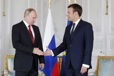 French President Emmanuel Macron (R) shakes hands with Russian President Vladimir Putin (L) at the Chateau de Versailles as they meet for talks in Versailles on May 29, 2017. Macron hosts Russian counterpart Vladimir Putin in their first meeting since he came to office with differences on Ukraine and Syria clearly visible. / AFP / / Philippe Wojazer