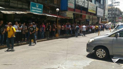 Curious commuters look on as the police scour the premises of the Professional Regulation Commission on Friday, May 12, for a possible bomb there. Jerold Tagbo/ Eagle News Service