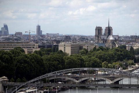 A picture taken on May 30, 2017 shows a general view of Paris with the Notre Dame Cathedral (R) and the Seine River. / AFP PHOTO / JOEL SAGET