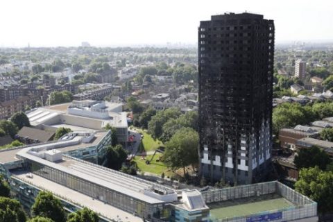 The remains of Grenfell Tower, a residential tower block in west London which was gutted by fire on June 14, 2017. Firefighters searched for bodies today in a London tower block gutted by a blaze that has already left 12 dead, as questions grew over whether a recent refurbishment contributed to the fire. / AFP PHOTO / Tolga AKMEN