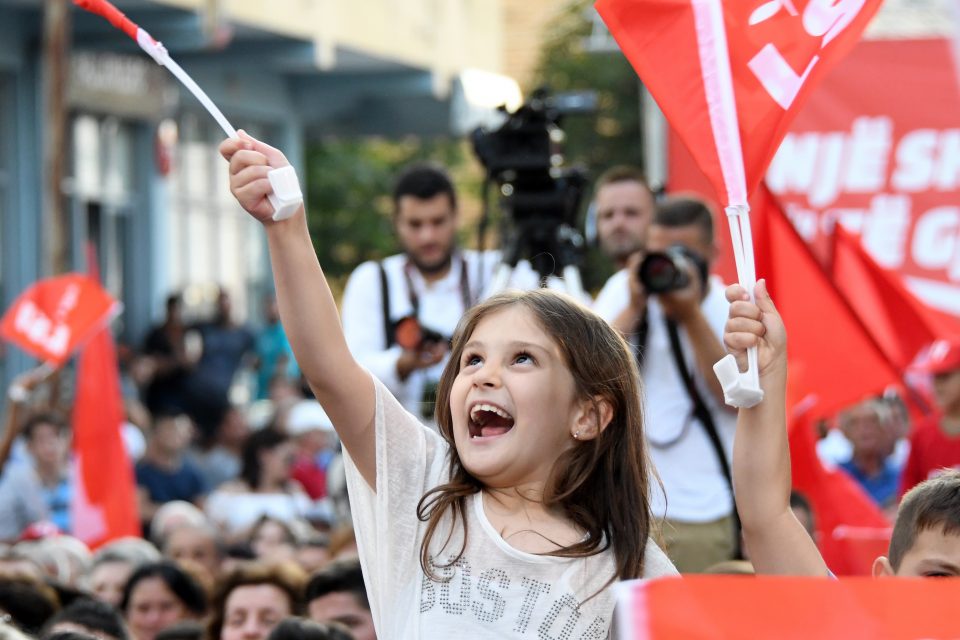 An Albanian child waves a flag during a campaign rally of the Albania's Socialist Movement for Integration (LSI) party held ahead of the upcoming general election in Kavaje on June 20, 2017. The legislative elections in Albania will take place on June 25, 2017. / AFP PHOTO / Gent SHKULLAKU