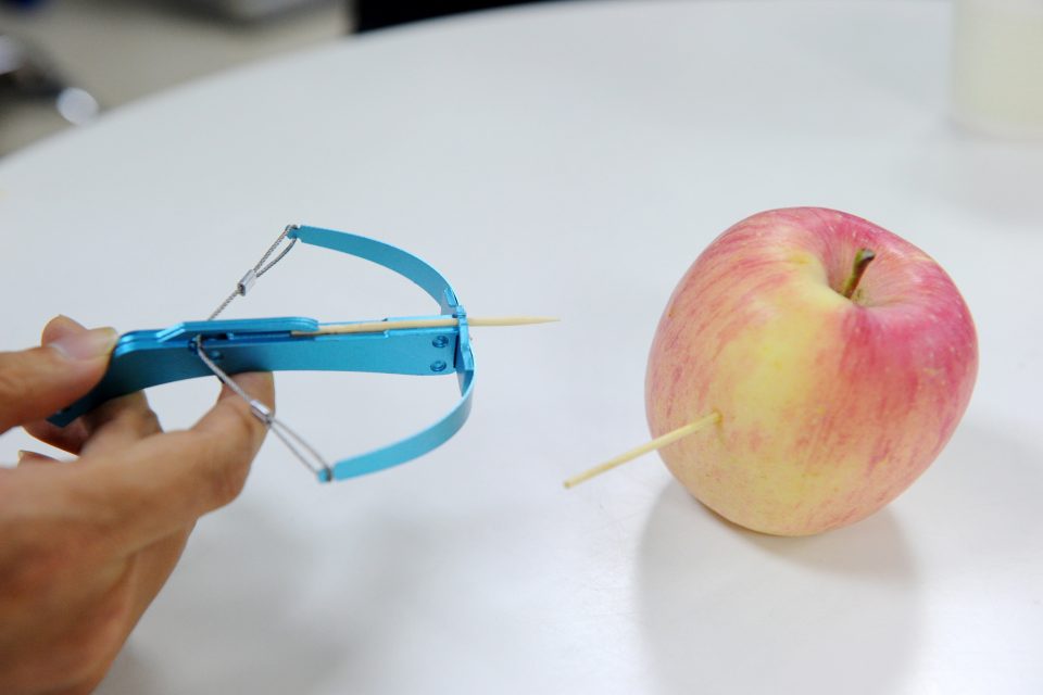 This photo taken on June 20, 2017 shows a man demonstrating a toothpick crossbow in Chengdu, in China's southwest Sichuan province. Handheld crossbows that can fire out needles and nails are the latest must-have toy in China but anxious parents want them banned before a young child gets blinded or worse. Selling online and in shops for as little as seven yuan (1 USD), so-called toothpick crossbows were originally designed to shoot out just that -- toothpicks. / AFP PHOTO / STR / China OUT