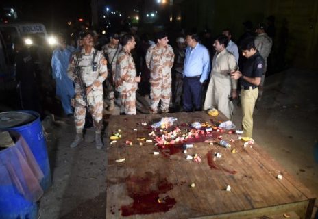 Pakistani security officials gather at the site of an attack on policemen by gunmen in Karachi on June 23, 2017. Four unknown attackers riding on two motorcycles shot the policemen when they were sitting a roadside restaurant at SITE area in western Karachi for the breaking their fast. / AFP PHOTO / ASIF HASSAN