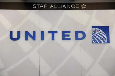 A United Airlines logo is seen behind the ticket counter at Chicago's O'Hare airport on August 13, 2013. The US Justice Department and several states sued Tuesday to block the $11 billion merger between American Airlines and US Airways, saying it would reduce competition and push up fares. AFP PHOTO / Mira OBERMAN / AFP PHOTO / MIRA OBERMAN