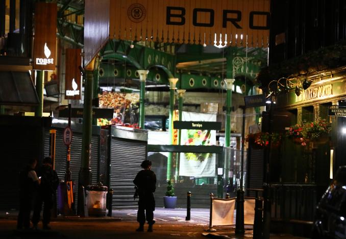 Armed police officers stand in Borough Market. REUTERS/Neil Hall