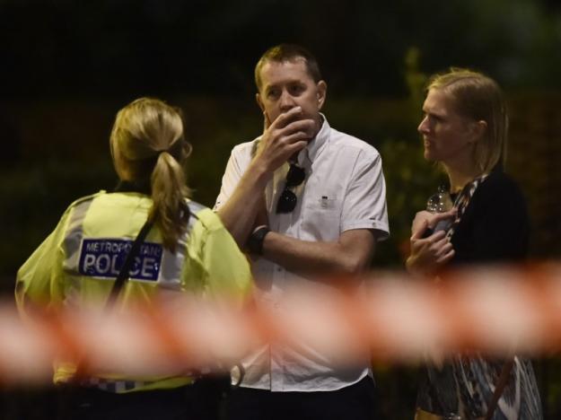 People speak with a police officer after an incident near London Bridge in London, Britain June 4, 2017 REUTERS/Hannah Mckay